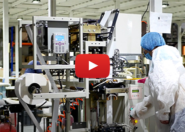 factory worker operating a production machine